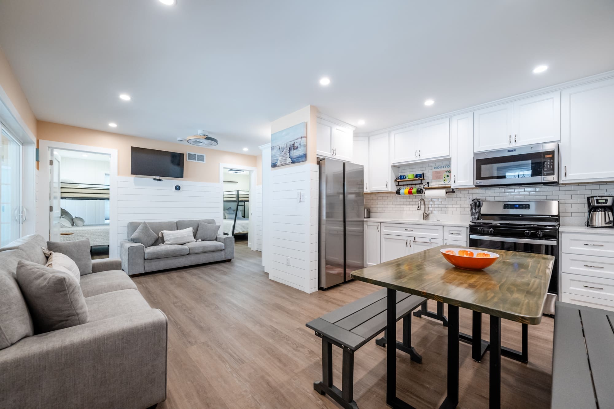 Open-plan living area with a full kitchen, dining table, and cozy seating
